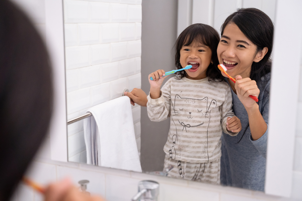 Mom and Kid Brushing Their Teeth Together